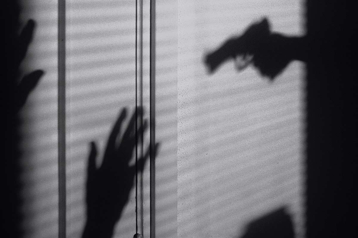 shadowgunthreat silhouette of gun aimed at hands up